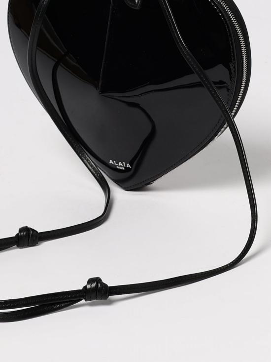26FW 알라이아 페이턴트 레더 쾨르백 AA1P003CA189 999 Black - ALAIA